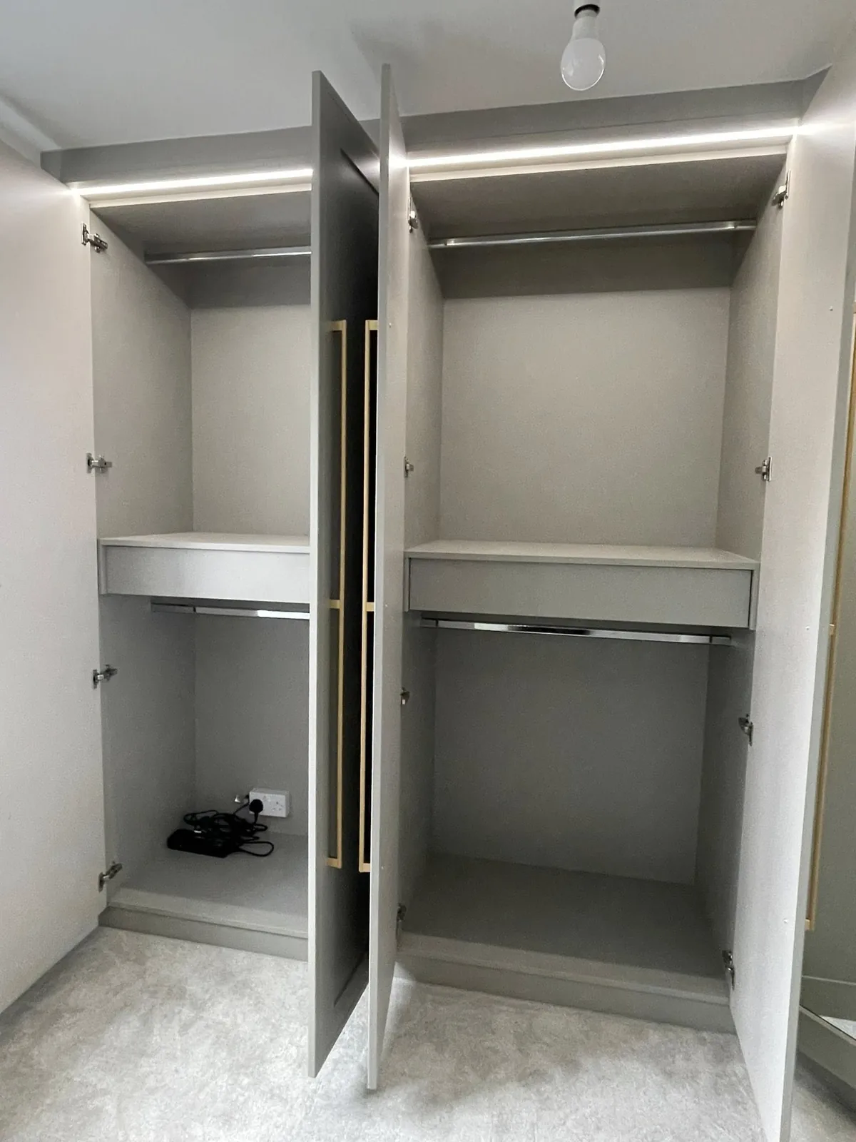 Open fitted wardrobe interior with hanging rails and shelving