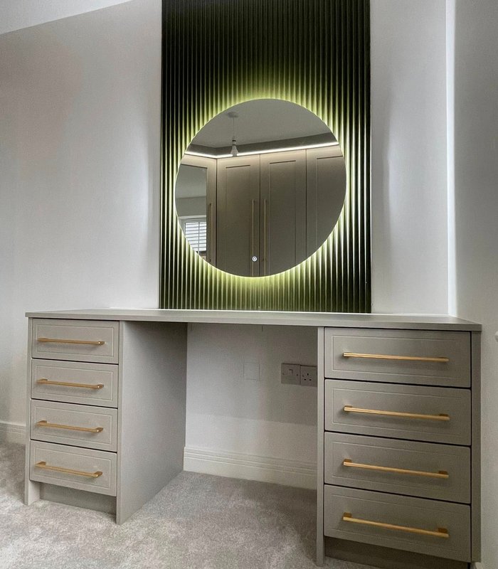 Grey fitted dressing table with an illuminated round mirror