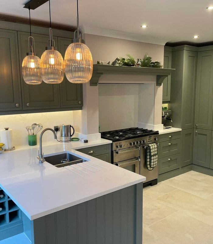Dark green shaker kitchen with a range cooker and pendant lights
