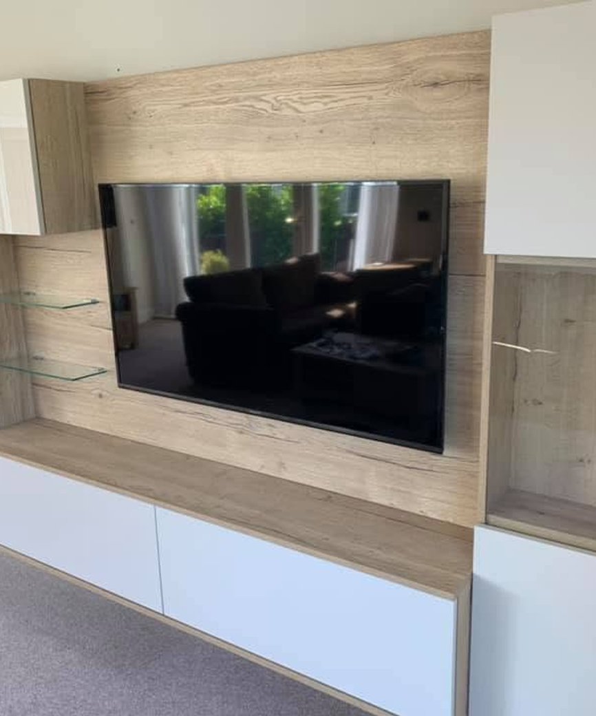 Fitted TV unit with built-in cabinets and display shelving