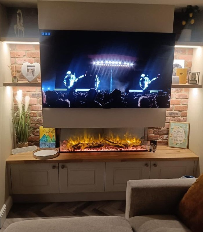 Fireplace media wall with stone-effect tiles and illuminated shelves