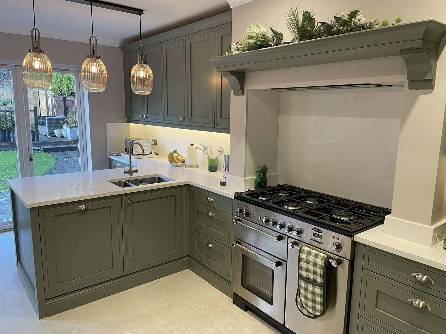 Olive green fitted kitchen with a range cooker